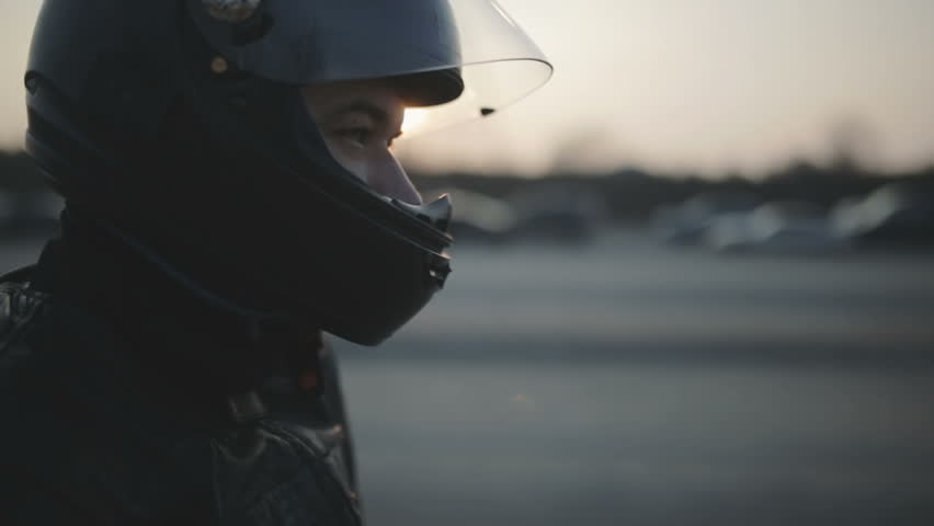 portrait of young attractive motorcyclist with black helmet on street. Man motorcycle biker  Royalty-Free Stock Footage #1009261943