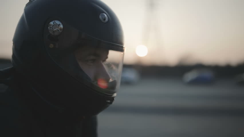 Portrait of young attractive motorcyclist with black helmet on street. Man motorcycle biker  | Shutterstock HD Video #1009261949