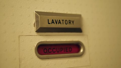 Airplane Lavatory Sign. Vacant and Occupied Message on Toilet Door. 4K.
