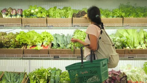 Young Mixed Race Woman Shopping in Grocery Store. Vegan Girl Choosing Fresh Green Salads and Organic Veggies. 4K.