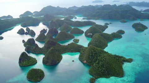 Gorgeous limestone islands are found in an idyllic, tropical lagoon in Wayag, Raja Ampat, Indonesia. This unique, equatorial region is best known for its vast array of marine biodiversity.