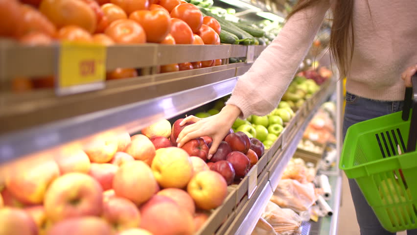 Woman selecting fresh red apples in grocery store supermarket sale, shopping marketplace food taking choosing apples girl with bag buying apples at shopping basket. 4 k apple fruits Woman's hand shop Royalty-Free Stock Footage #1009287932