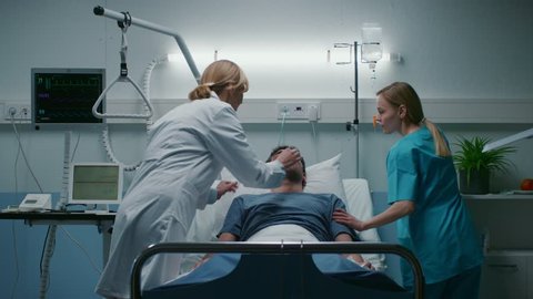 Emergency in the Hospital Doctor and Nurse Rush into the Ward to Safe Dying Patient. Man is Lying on the Bed without Signs of Life. Doctors Do Everything to Resuscitate Him.  Shot on RED EPIC-W 8K