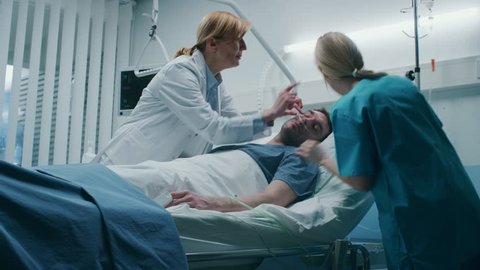Emergency in the Hospital, Doctor and Nurse Rush into the Ward to Safe Dying Patient. Man is Lying on the Bed without Signs of Life. Doctors Do Everything to Resuscitate Him. Shot on RED EPIC-W 8K 