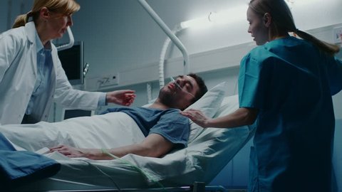 Emergency in the Hospital, Doctor and Nurse Rush into the Ward to Safe Dying Patient. Man is Lying on the Bed without Signs of Life. Doctors Do Everything to Resuscitate Him. Shot on RED EPIC-W 8K