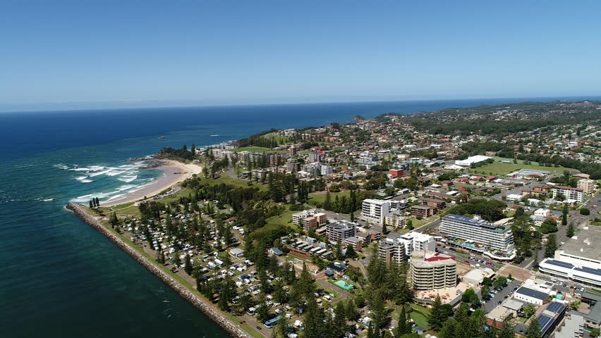 Port Macquarie CBD in aerial panning fly facing town coast and river shore above local streets, houses, caravan parks and promenade
 Royalty-Free Stock Footage #1009298957
