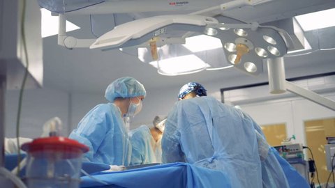 Medical Team Performing Surgical Operation in Modern Operating Room.