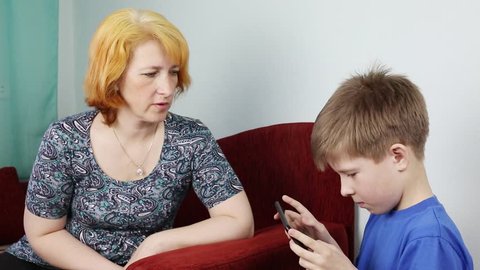 Mom scolds his son for a long time with a gadget