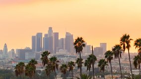 Sunset time-lapse of Downtown Los Angeles with palm trees