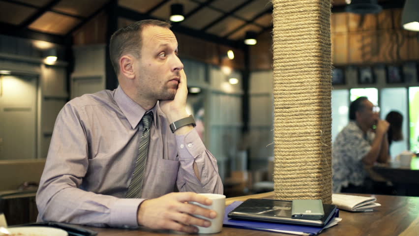 Sad, unhappy businessman sitting in cafe
 | Shutterstock HD Video #10093187