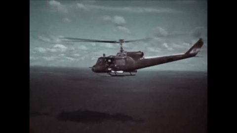 CIRCA 1960s - The crew of a Huey combat helicopter is diverted following its first mission to escort a heliborne troop lift.