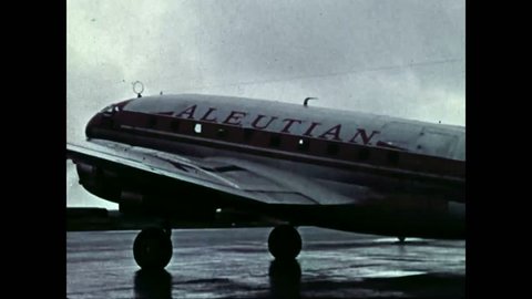 CIRCA 1958 - An Aleutian Airways plane and a C-123 transports cargo to Alaska.