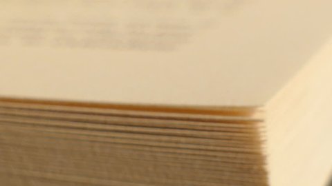 Extreme close-up of a book pages in turning action, book with turning pages
