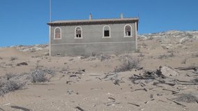 HD high quality summer day video of abandoned diamond mining town of Kolmanskop located near coastal harbour town Luderitz in the Namib Desert Sperrgebiet area in the south of Namibia, southern Africa