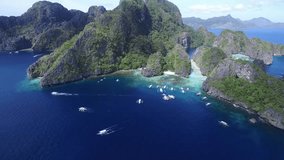 Big Lagoon, El Nido, Palawan, Philippines.  Big Lagoon is dotted with dark limestone cliffs. The entrance to the lagoon has shallow water. It's El Nido Island Hopping Tour A