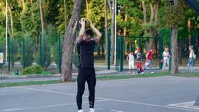 Basketball freestyle, a player jumps over a teammate and makes a slam dunk. Basketball training outdoors in the park. Healthy lifestyle. Video in full hd format