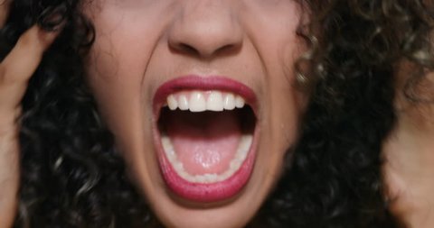Closeup of angry woman. African American girl showing fear, terror and frustration. Slow motion