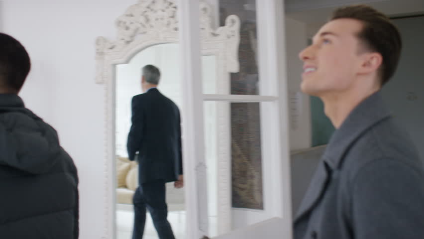 Young male couple viewing a property together, in slow motion