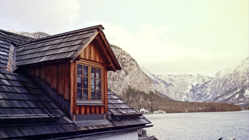 Wooden house against alpine mountain landscape