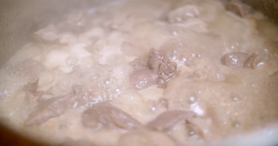 Boiling lamb meat in a saucepan | Shutterstock HD Video #1009369487