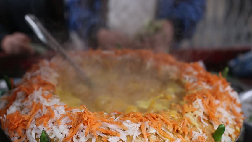 Street food in Asia, Nepal. Hands, cooking  traditional snack outdoor, rise, carrot