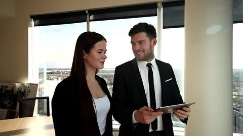 Business meeting at Office. Skyscraper view. Man and woman talking business