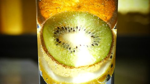 Fruit fresh from mineral sparkling water. Slices of lemon orange fruit kiwi fruit. A refreshing drink. A beautiful cocktail with bubbles