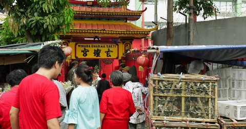 JAKARTA - Indonesia. March 26, 2018: Chinese temple gate of Jin De Yuan Temple or Vihara Dharma Bhakti with crowded people at Petak Sembilan, Glodok, Jakarta. Shot in 4k resolution