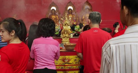 JAKARTA - Indonesia. March 26, 2018: Buddhist people celebrating Chinese New Year by praying in front of Buddha statue at the Vihara Dharma Bhakti. Shot in 4k resolution