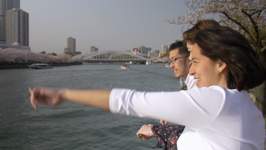 International friends enjoying the river during sakura picnic.