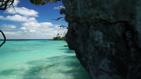 Slider shot from cliff into beautiful ocean at Lifou tropical island beach, New Caledonia.