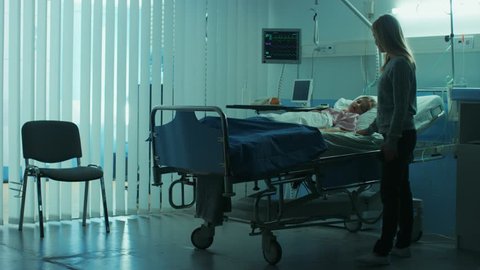 Sick Little Child Lying in the Hospital Bed Sleeping, Her Mother Worries Sits on a Chair Beside, Hoping fore the Best. Dramatic Family Moment. Shot on RED EPIC-W 8K Helium Cinema Camera.