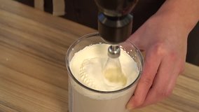 Cream cheese being mixed in a food processor and blender