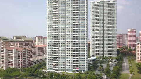 Ascending Aerial Shot of High Rise Condominums among Pubic Housing Estates in Singapore
