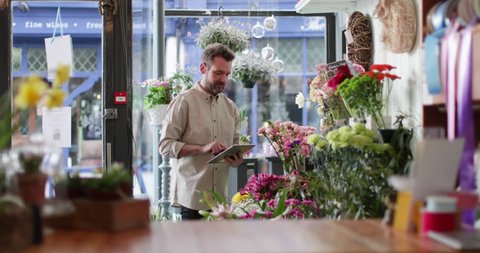 Small business owner using digital tablet in a florist