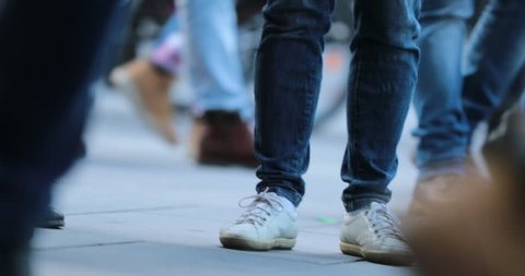 Low-angle Legs of Crowd People Walking on the Street. Close-up of Crowd feet in 4K 60fps