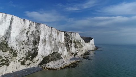 Aerial bird view flying past The White Cliffs of Dover they are cliffs that form part of the English coastline facing the Strait of Dover and France and are part of the North Downs formation 4k