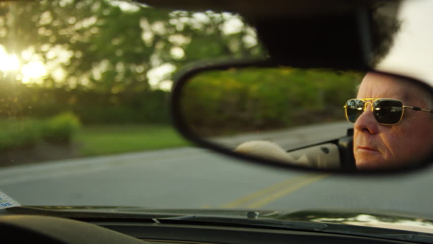 Closeup On A Rearview Mirror's Reflection Of Carefree Senior Man Driving His Luxury Convertible, His Dog In His Lap - Shot On Red Scarlet-W Dragon In 4K/ Slow Motion