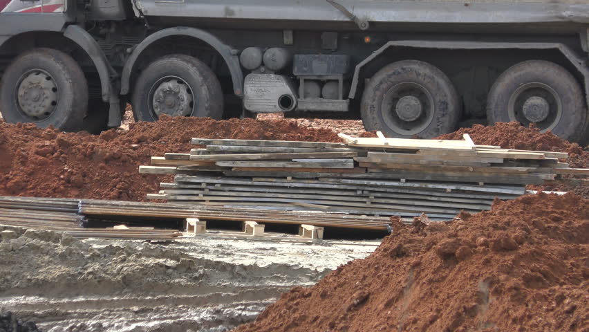truck unloads clay on the construction site