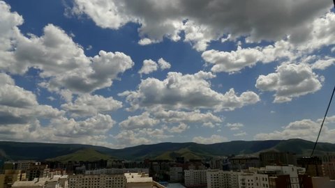 Picturesque flying clouds over the city and mountains, time lapse. Ulaanbaatar, Mongolia.