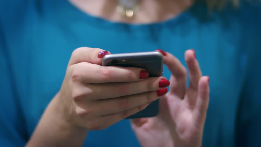Woman hand typing mobile message on screen smartphone. Close up female hands holding smartphone and browsing website Royalty-Free Stock Footage #1009445801