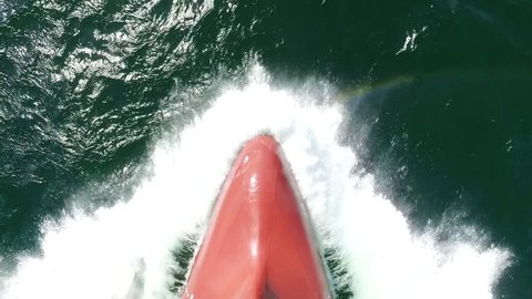 Splash of a sea wave against cargo ship's bow, slow motion shot