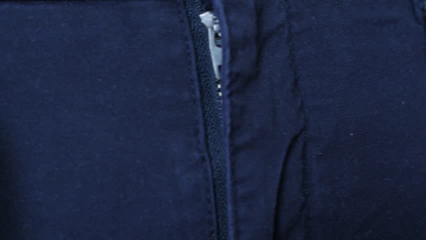 unfastening the belt on trousers, fly, slit