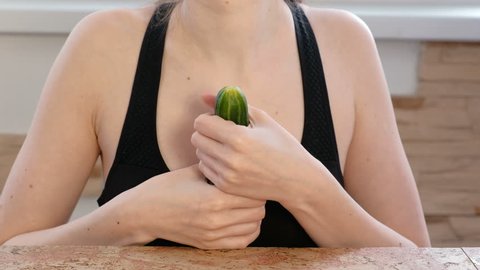 Woman hands holding cucumber and play with it. Safe sex concept.