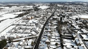 Aerial drone footage of suburban houses after snowy winter morning 