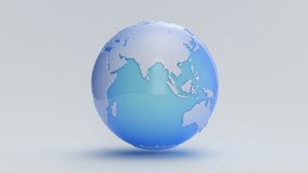 A blue Earth globe rotates on a white cyc (Loop).