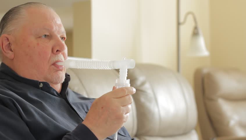 Man using a nebulizer | Shutterstock HD Video #1009490273