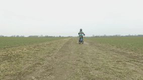 Little boy riding a bike.	
Boy riding a bike along the cycle path. Aerial view. Stabilized video.