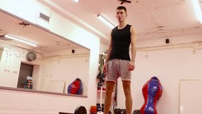 Strong young athlete doing practice in the gym. Dolly gimbal 4K video.