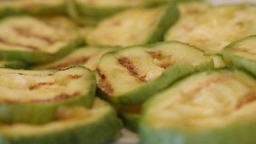 Hot Pepo cylindrica slices close-up 4K 2160p 30fps UltraHD footage - Heat evaporates from grilled zucchini cuts 3840X2160 UHD video